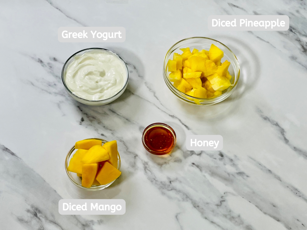 The only ingredients used here are Greek yogurt, diced mango, pineapple, and honey.